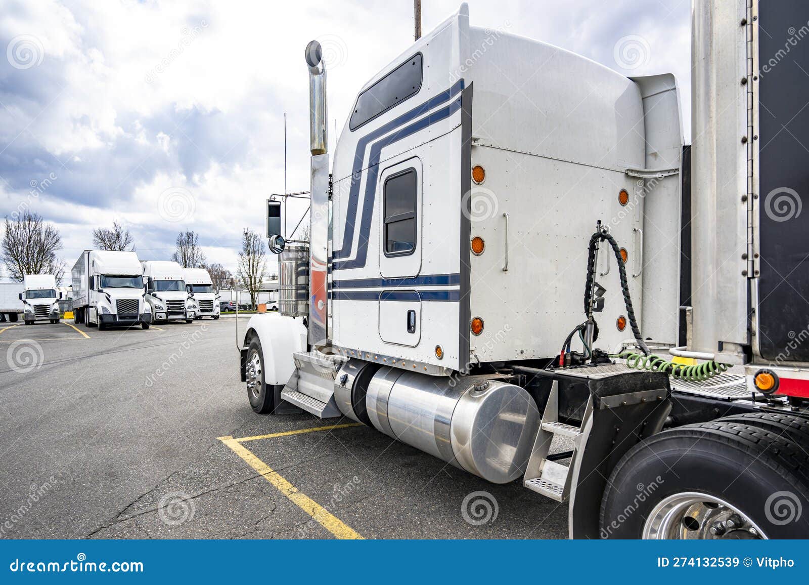 big rig american bonnet classic white semi truck with extended cab for truck driver comfort standing on the truck stop parking lot