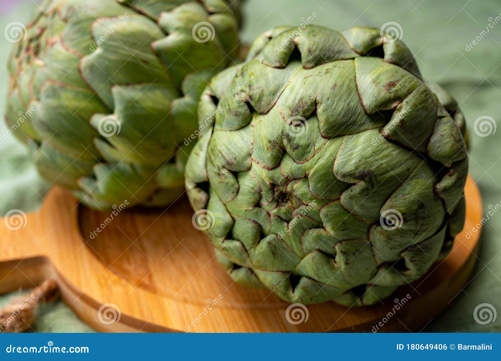 big ripe uncooked green globe artichoks vegetables
