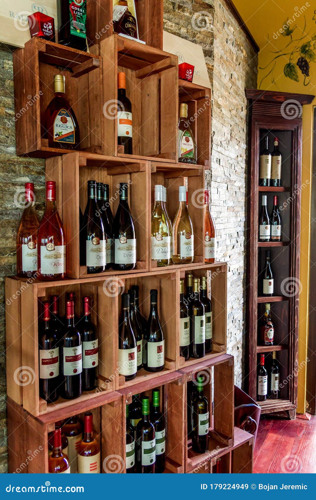 A Big Shelf with Wine. Shelf with Wine Bottles Editorial Stock Image