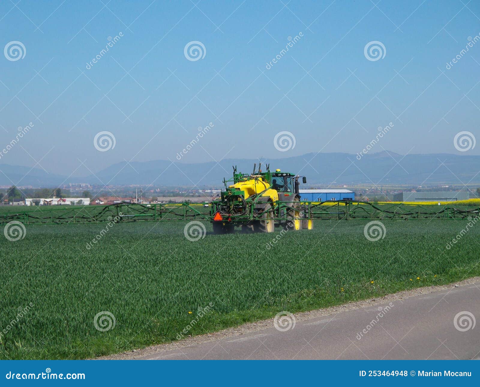 a big tractor irrigates the field