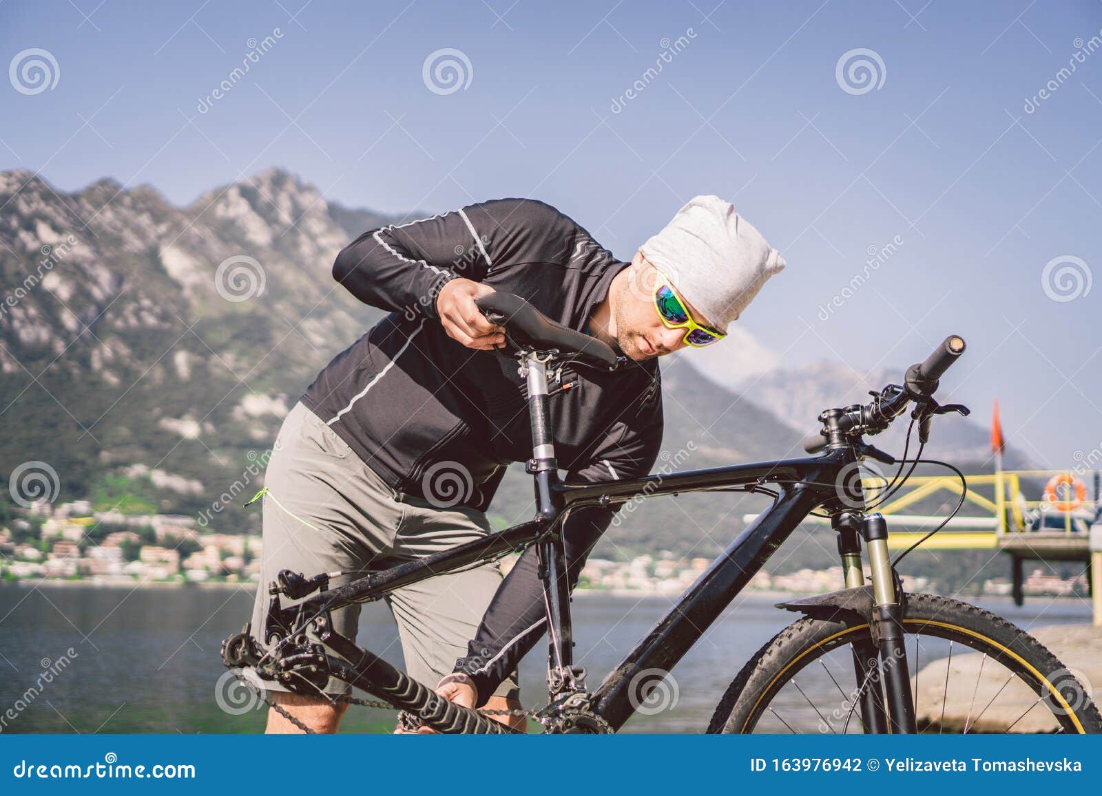 Bike Repair Man Repairing Mountain Bike Cyclist Man In Trouble Rear Wheel Wheel Case Of Accident Man Fixes Bike Near Stock Photo Image Of Mountains Punch