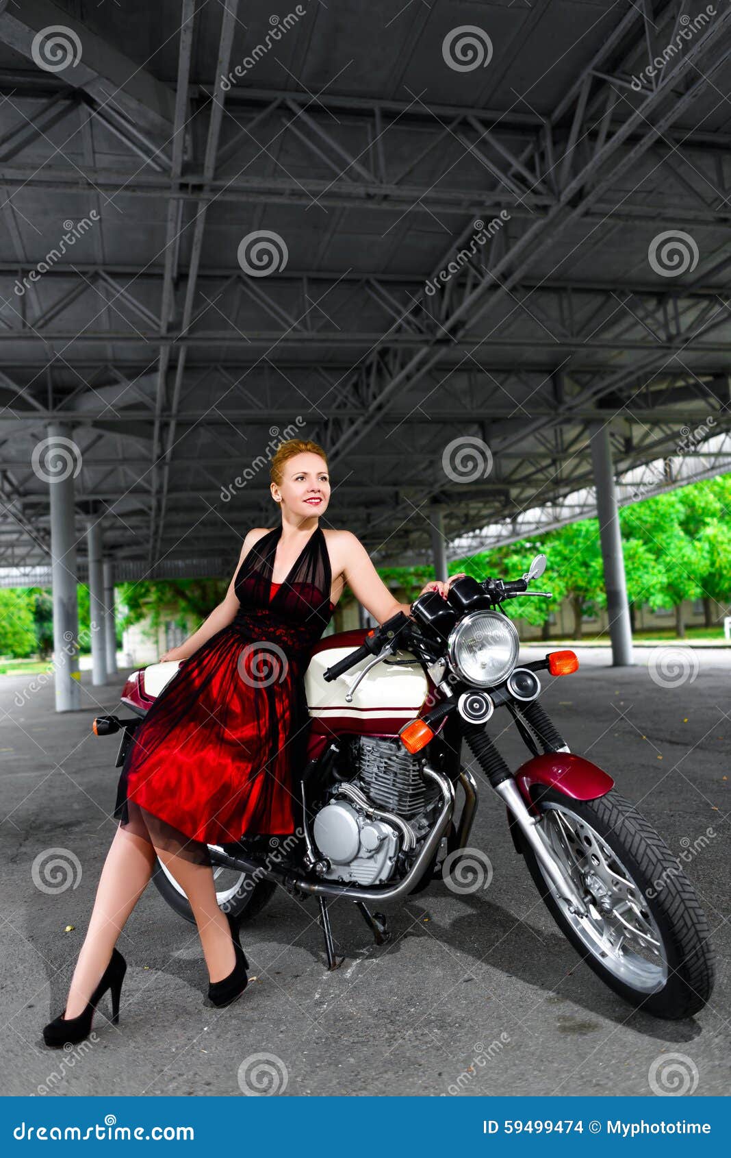 Biker Girl in Dress on a Motorcycle Over the Stock Photo Image of
