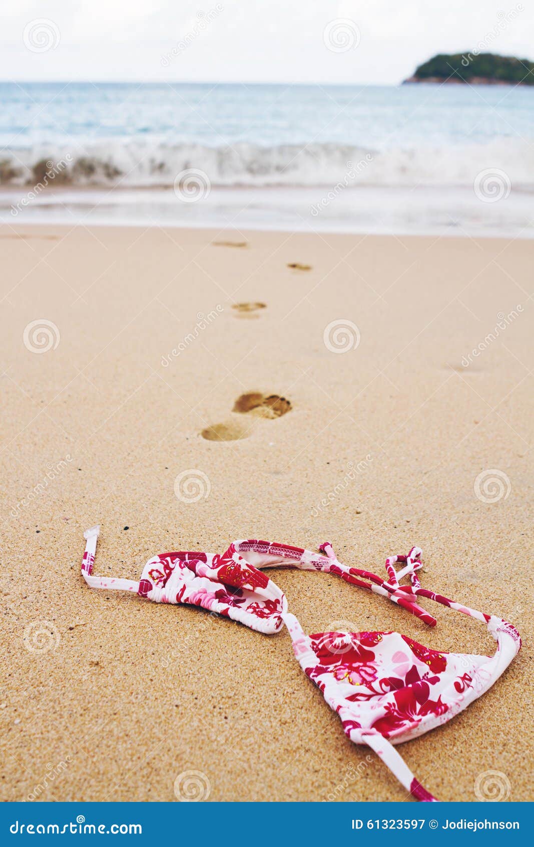 Bikini Top Lying on Beach with Footprints into Surf Stock Image Image