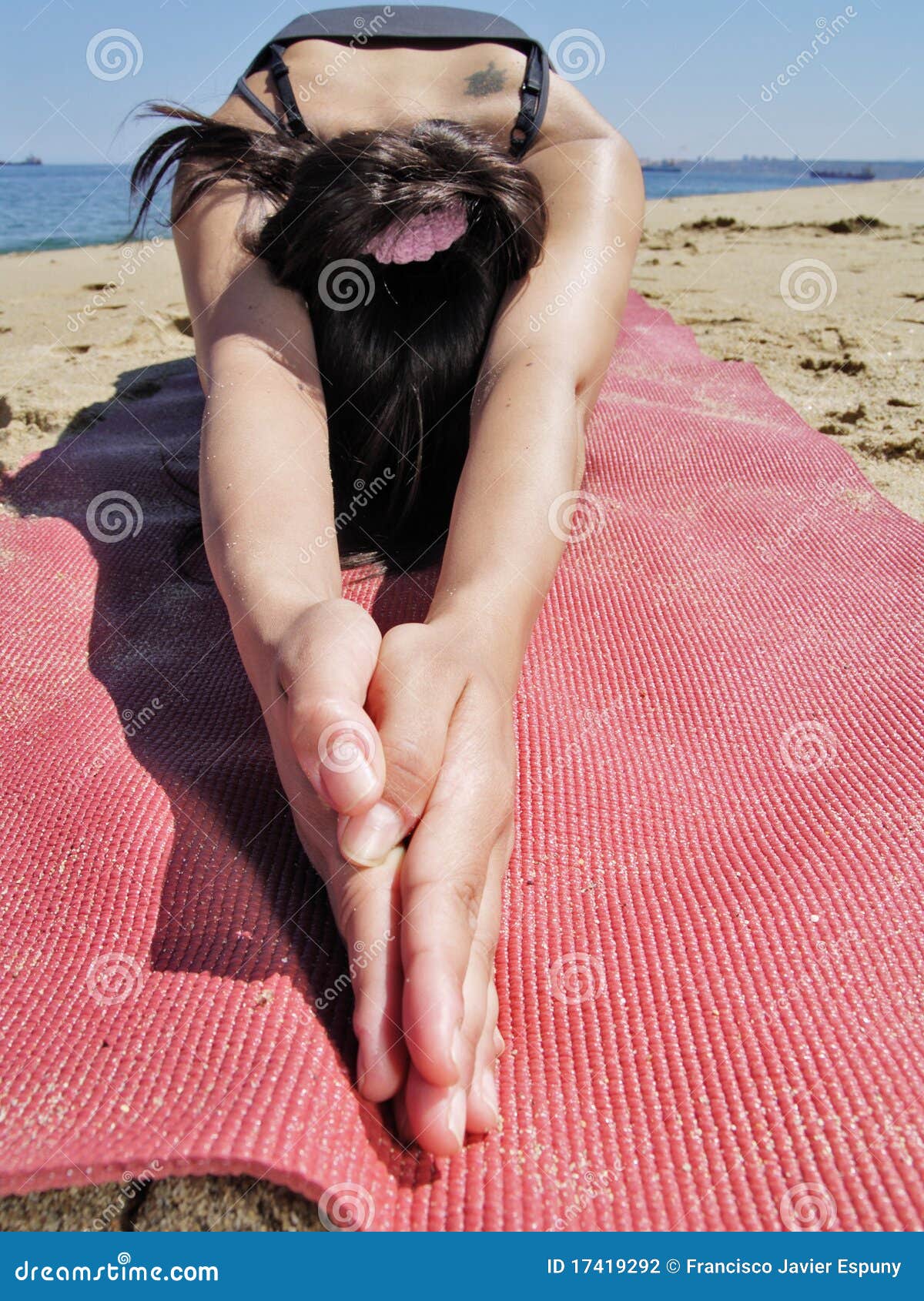 bikram yoga ardha kurmasana pose at beach