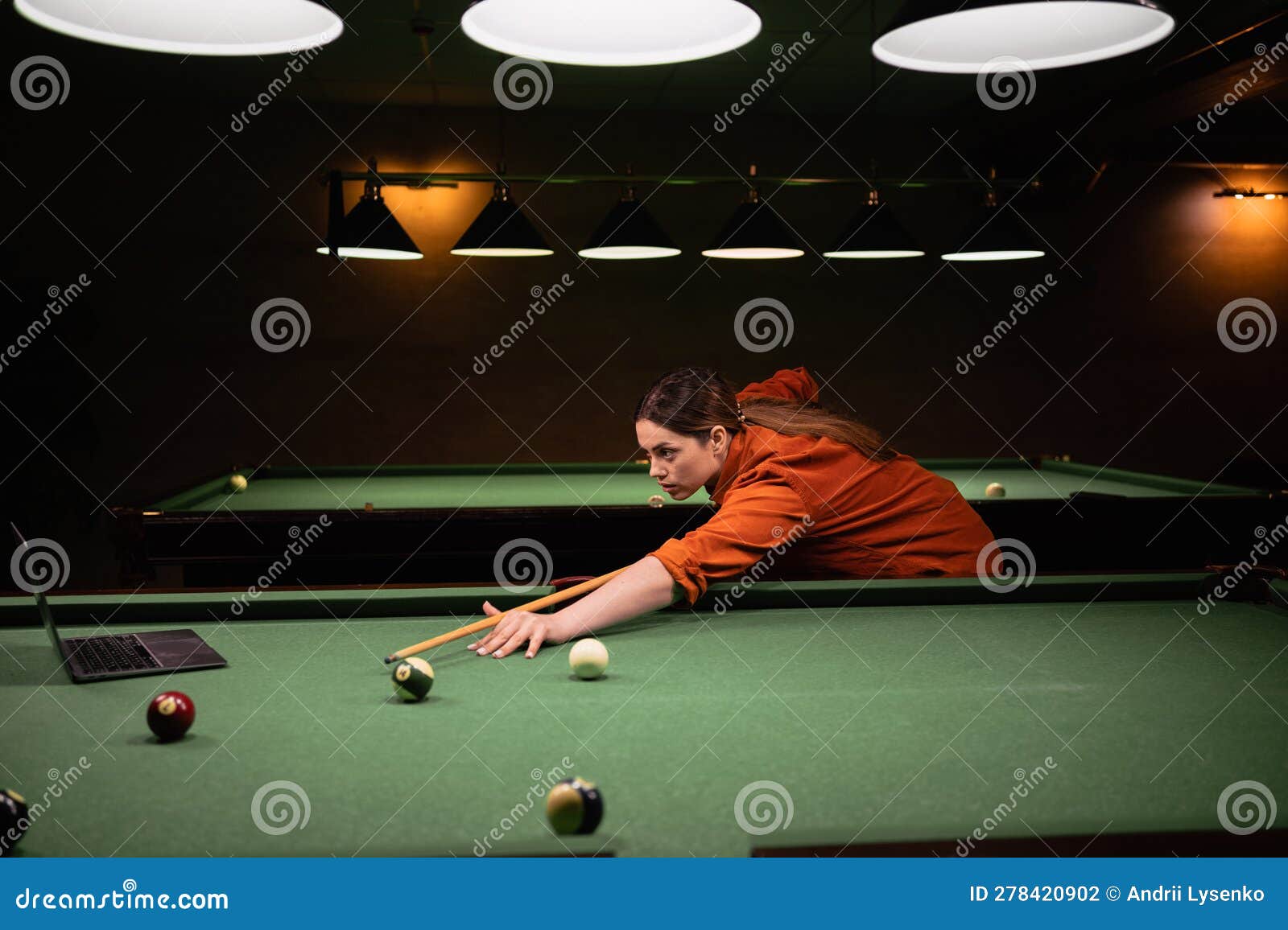 Billiard Game Online Training Course, Woman Playing Billiards Watching Tutorial Using Laptop Stock Photo