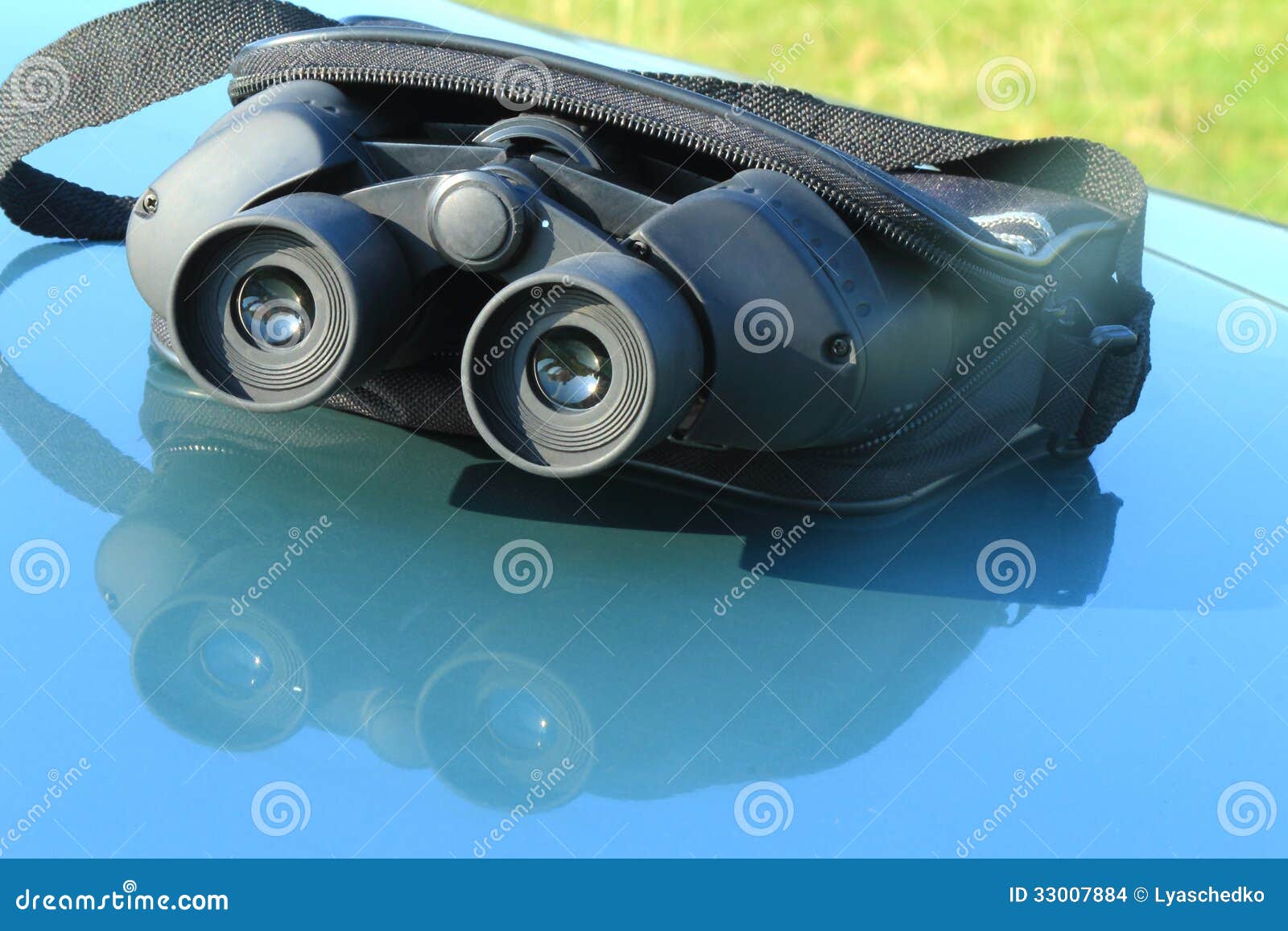 Binoculars in the Pouch on the Hood of the Car. Stock Photo Image of