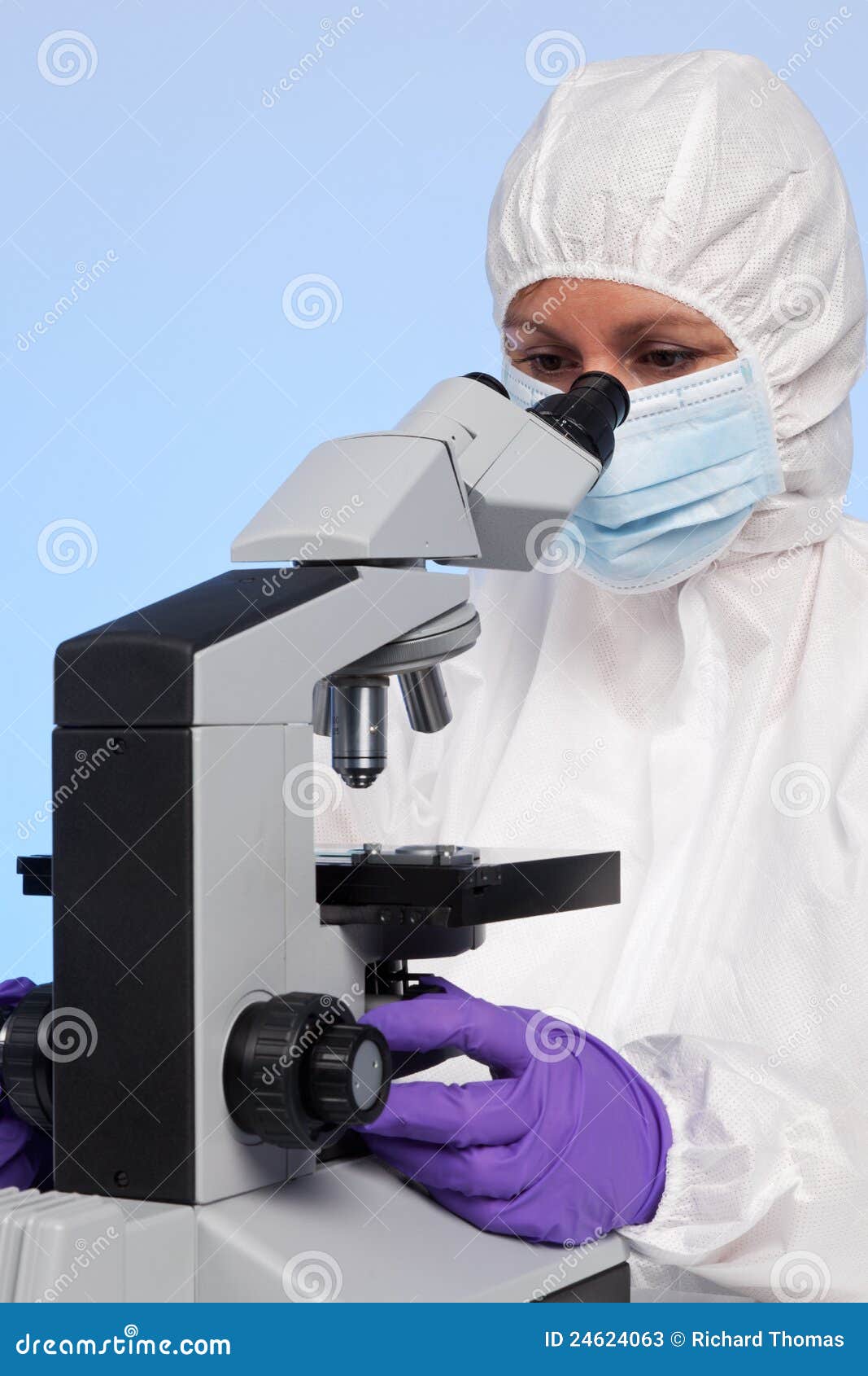 biochemist looking through a microscope