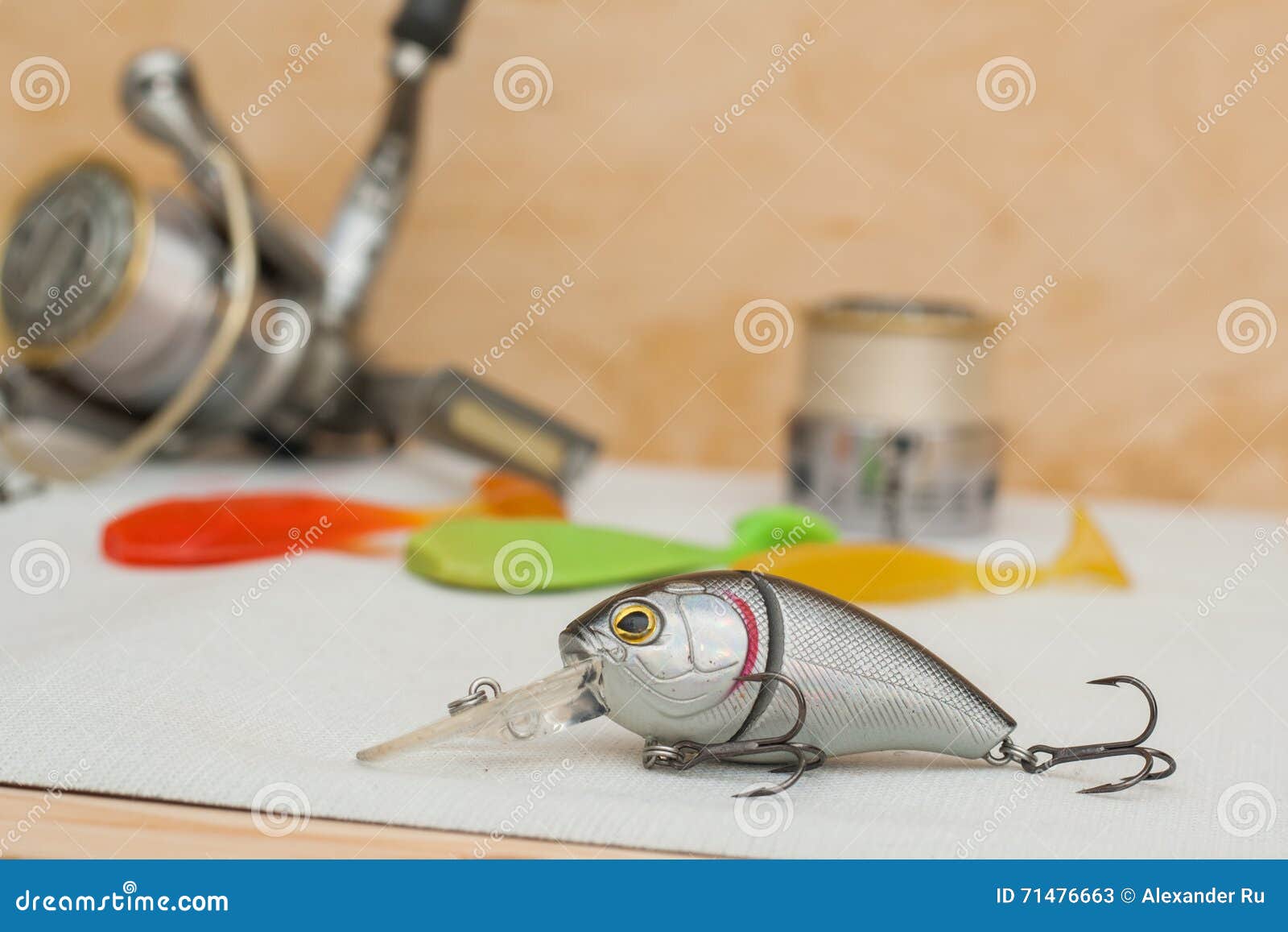 Bipartite Lure Lies on a White Cloth on a Background Inertialess Coil and  Rubber Lures Different Colors. 11/05/2016 Stock Image - Image of  illustrative, fish: 71476663