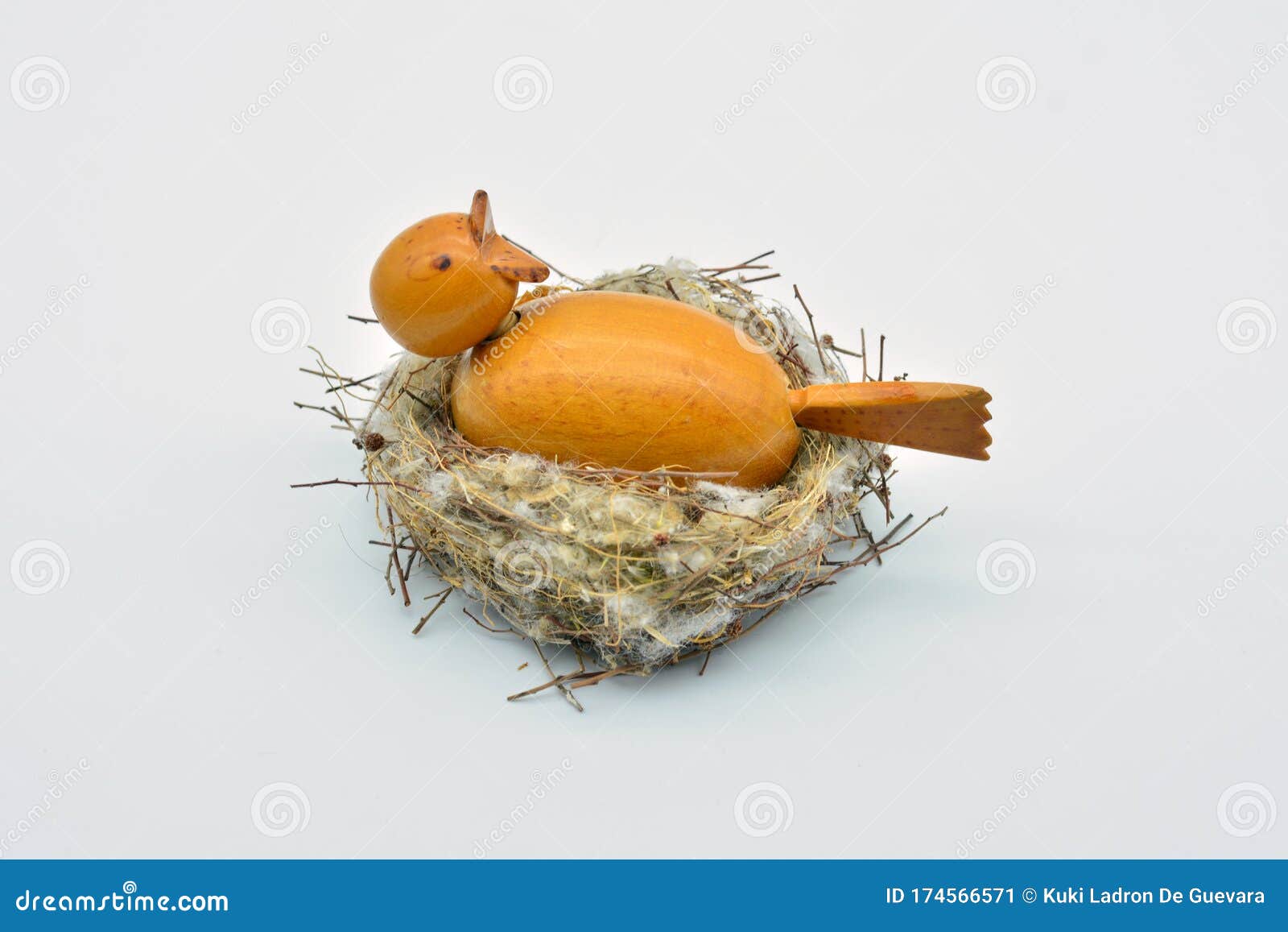 bird made of wood on a natural nest