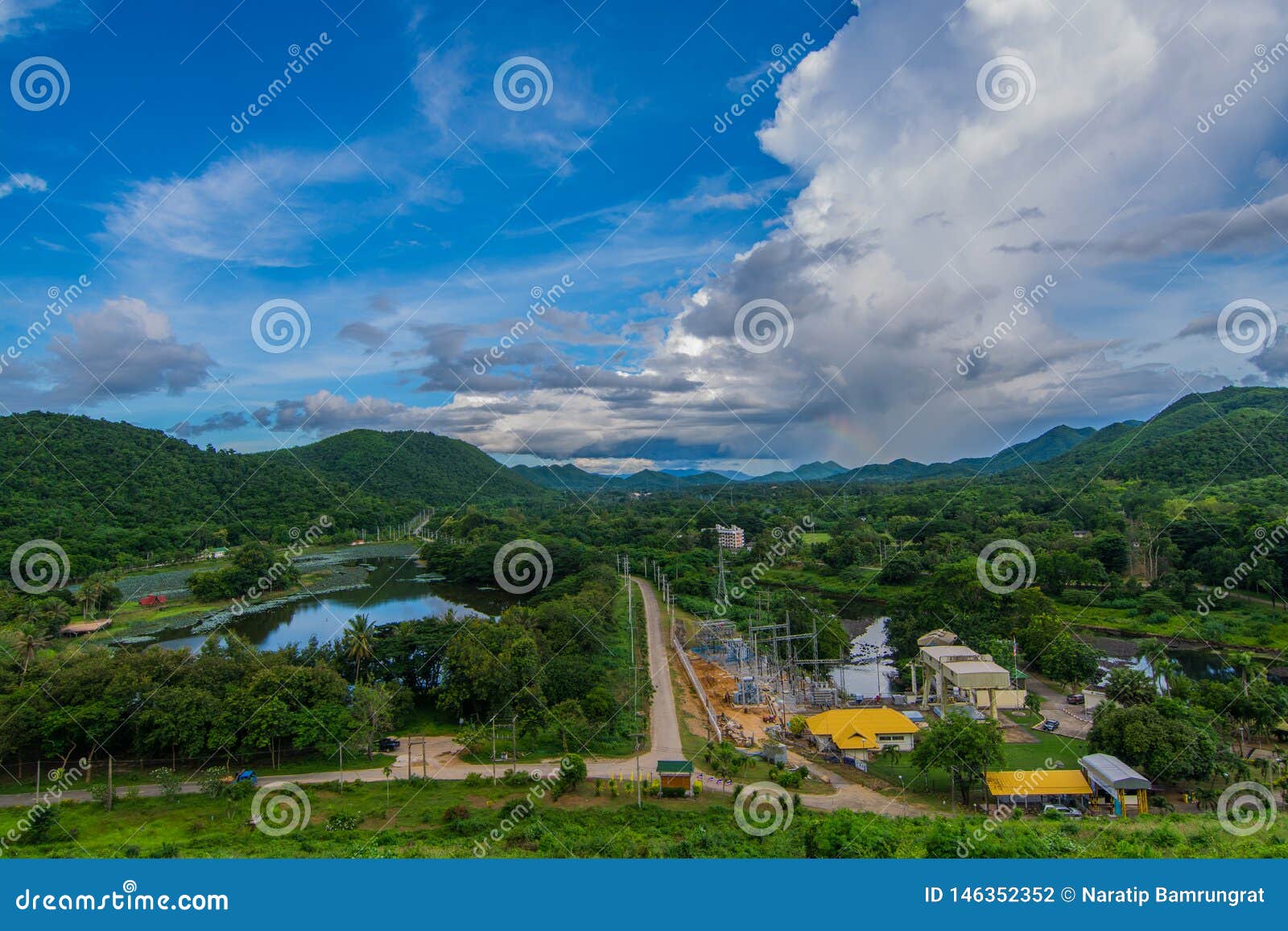 bird`s eye view, see the reservoir and small power plant in the middle of the mountainl