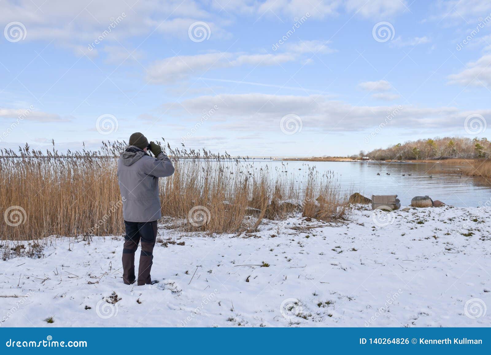 birder by a bay in winter season