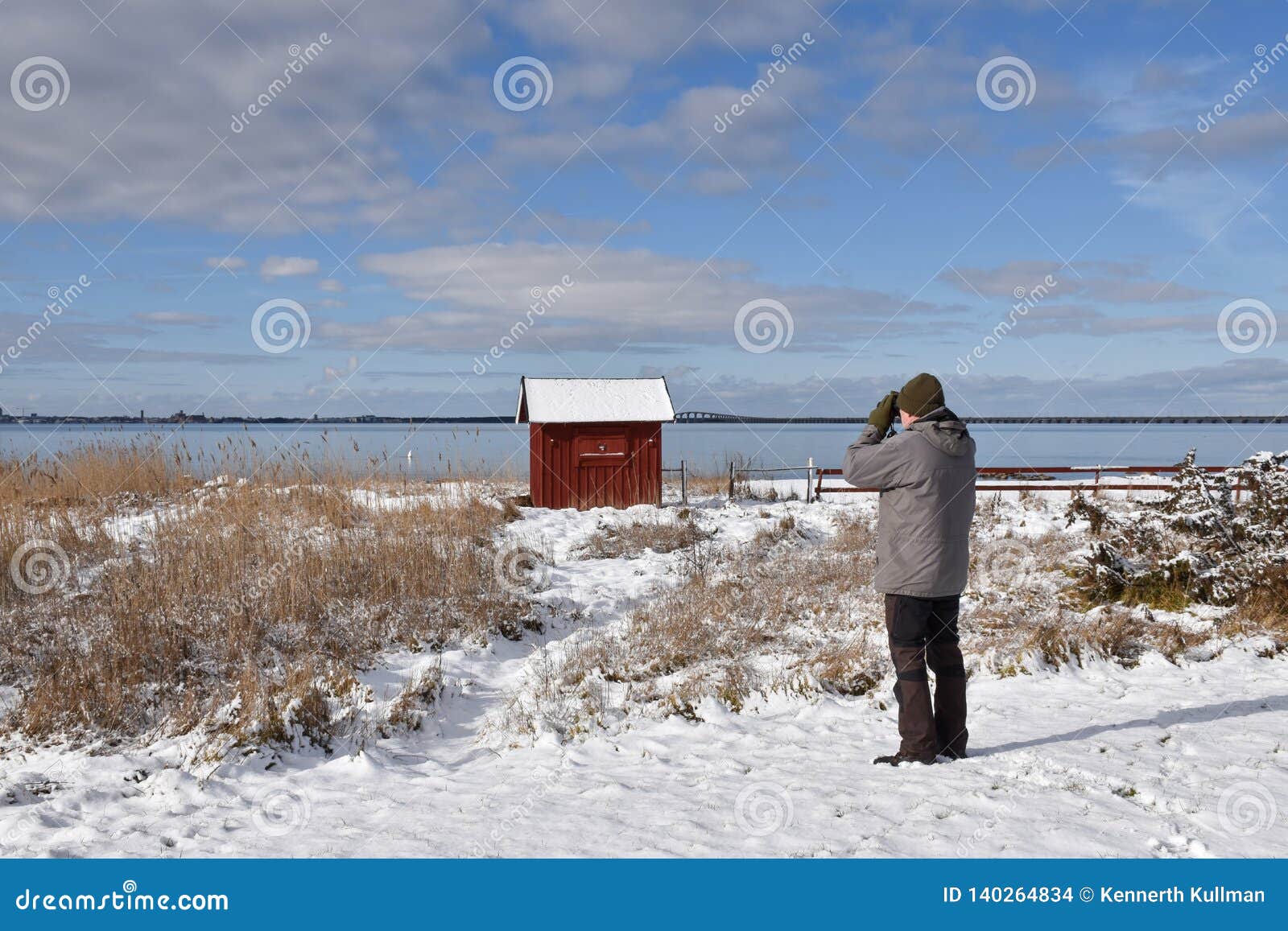 birder by the coast in winter season