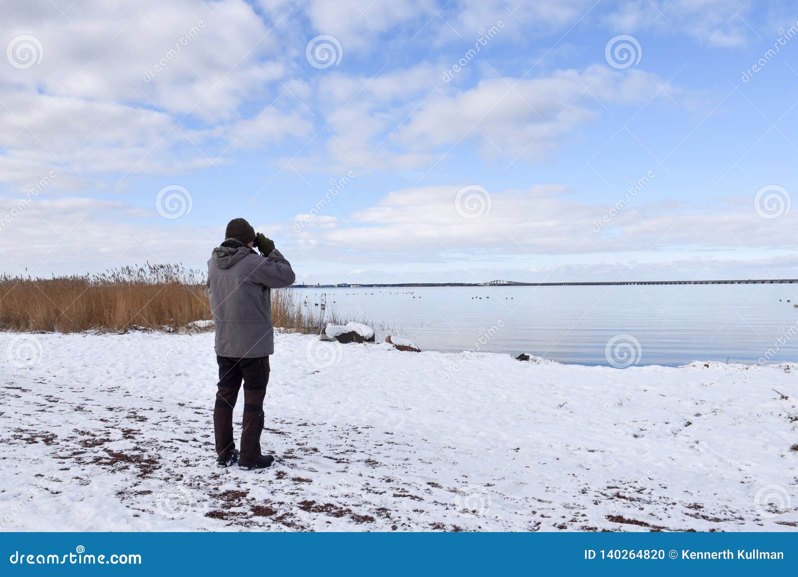 birder by a coast in winter season