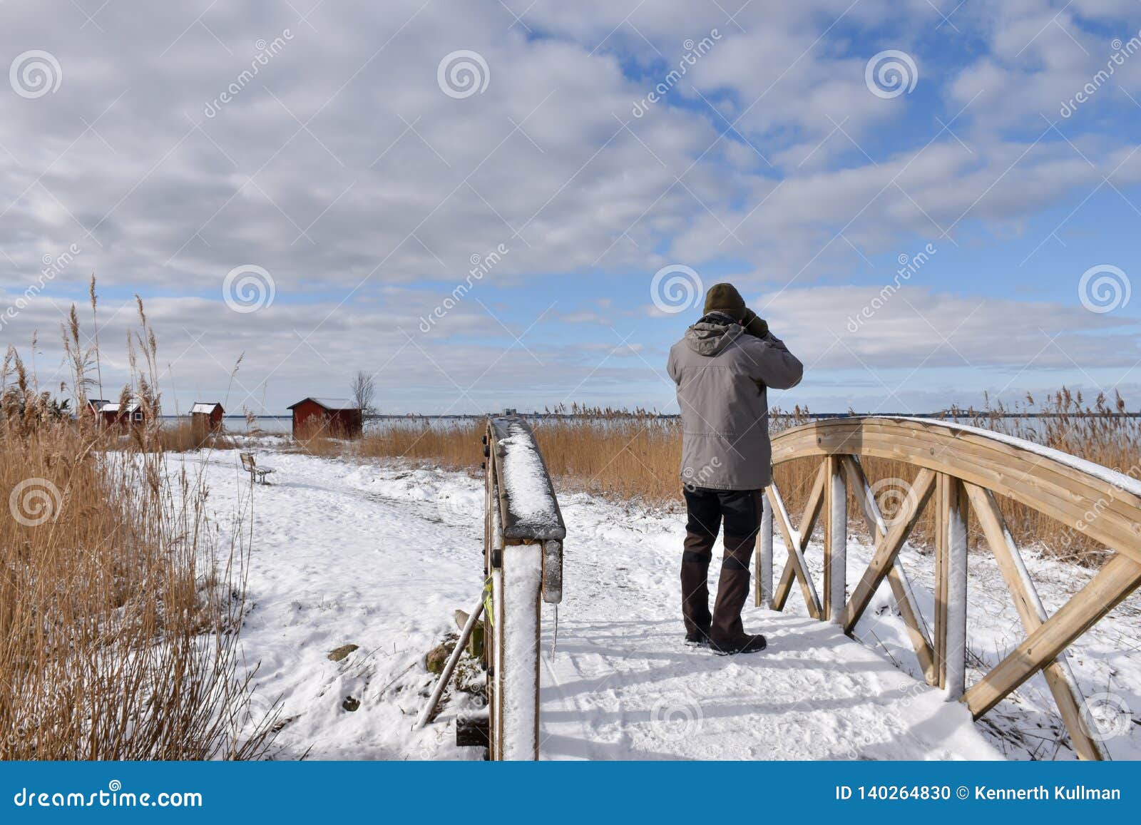birder on a wooden footbridge