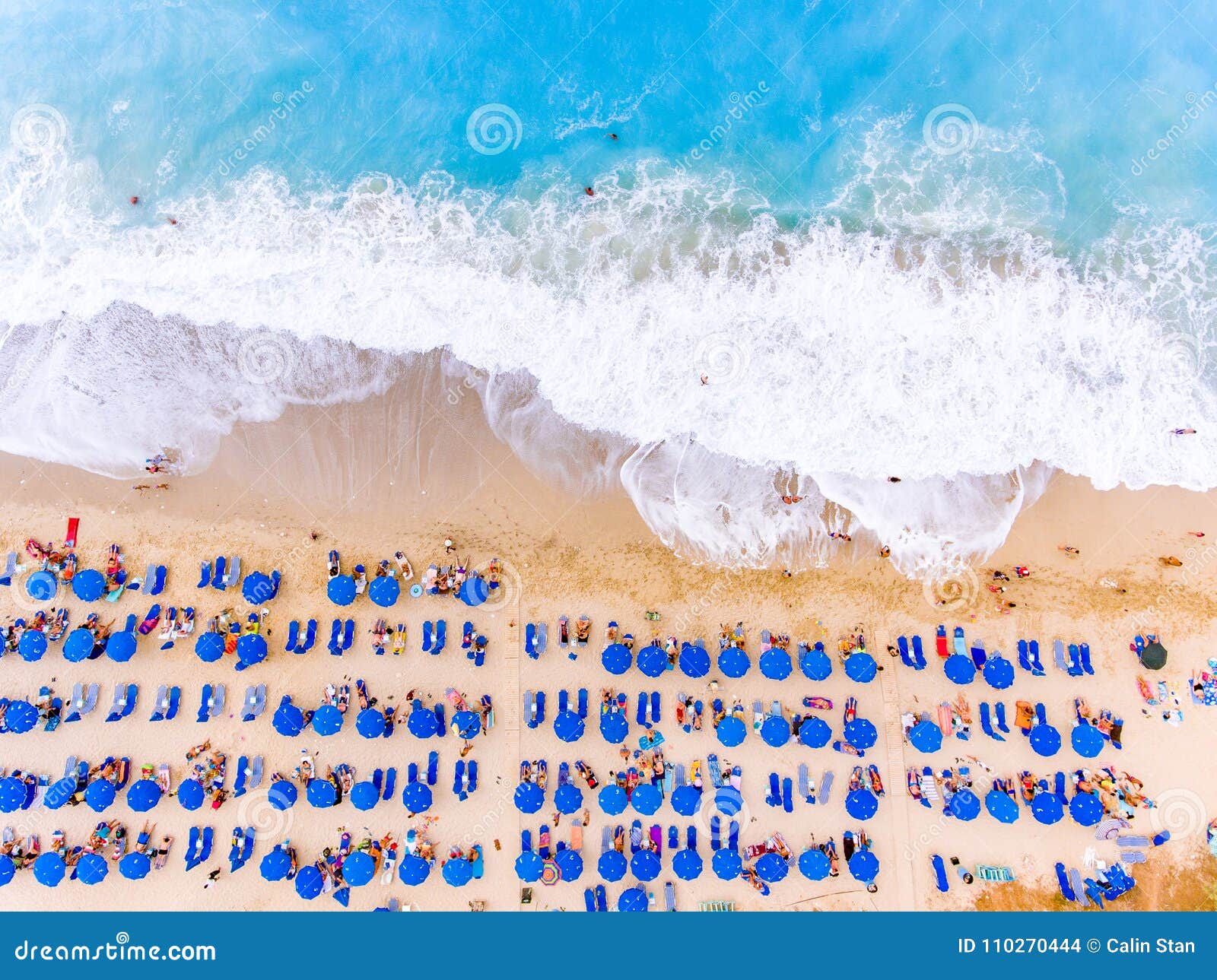 Birds Eye View of a Beach with Big Waves, Sunbeds and Umbrellas ...