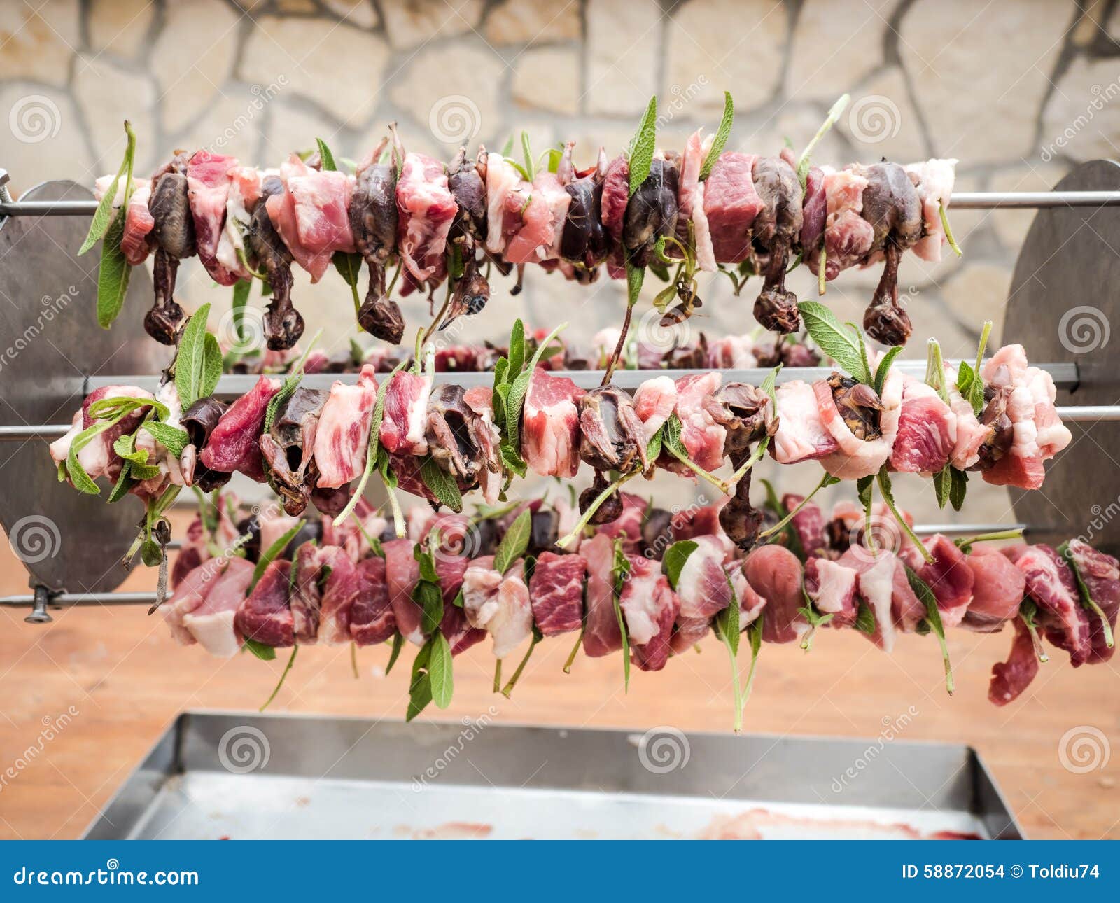 Birds on the Spit with Meat, Bacon and Sage Ready To Be Cooked Stock