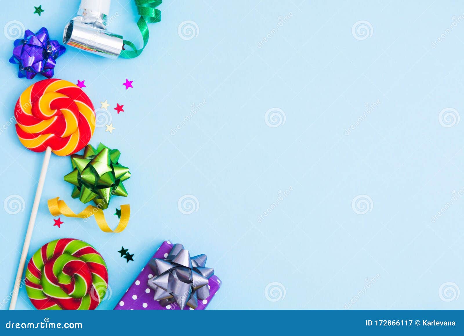 birthday background with candies, bows, confeti and gift box over blue backgroud