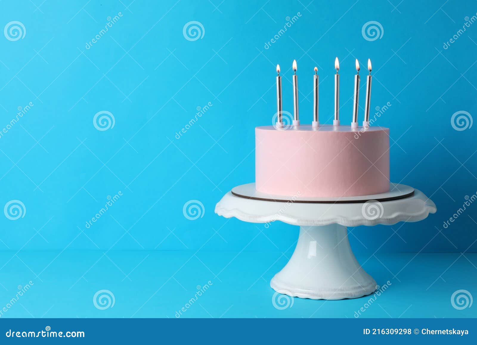 Birthday Cake with Burning Candles on Light Blue Background, Space for Text Stock Photo Image