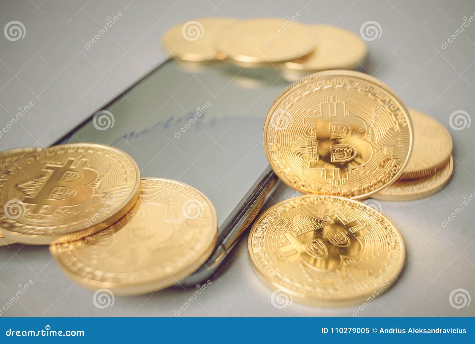 Bitcoin crypto currency. Bitcoin BTC. Crypto currency. Macro shot of golden coins placed on smartphone. Blockchain technology, bitcoin mining concept.