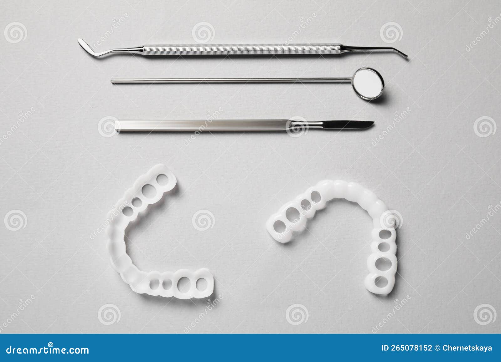 Bite Correction. Mouth Guards and Dentist Tools on Light Grey
