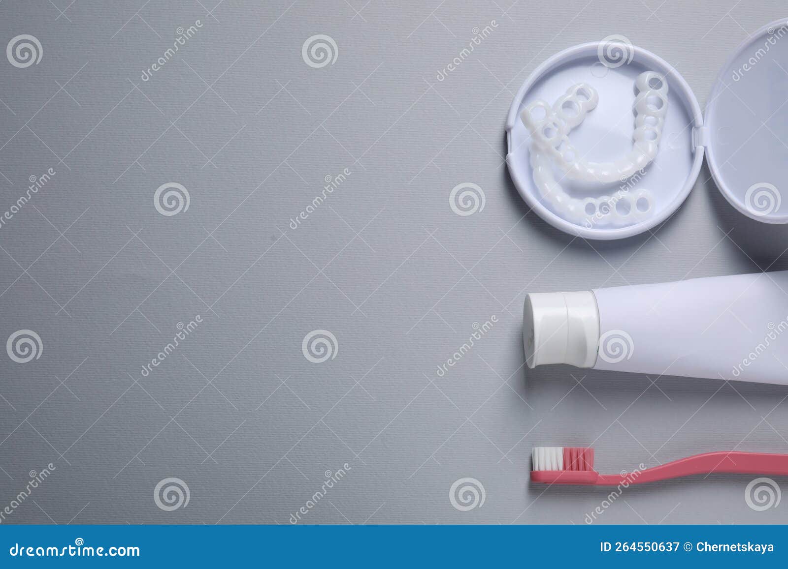 Bite Correction. Toothpaste, Brush and Dental Mouth Guards on Grey