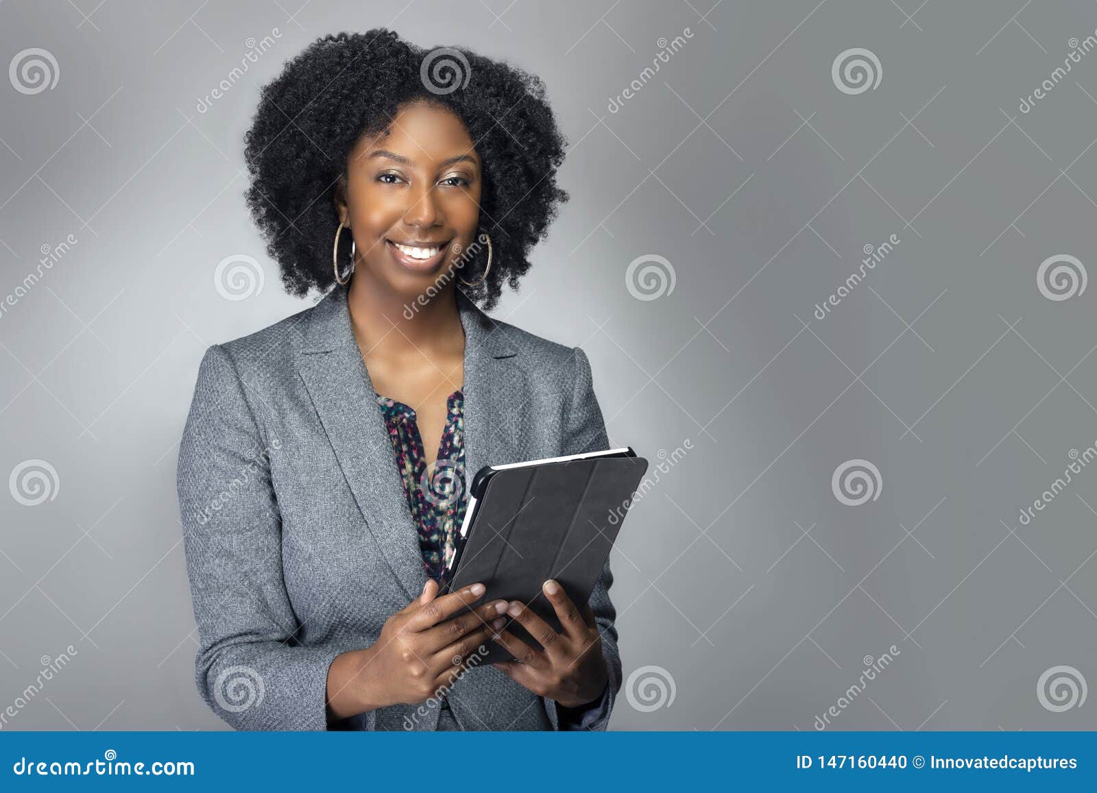 female author or businesswoman keynote speaker with tablet
