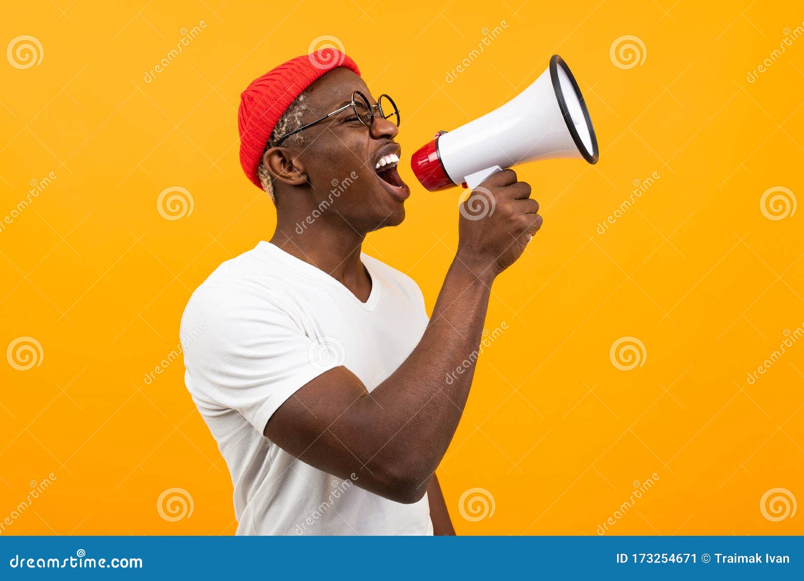 black african man speaks in megaphone on  yellow background