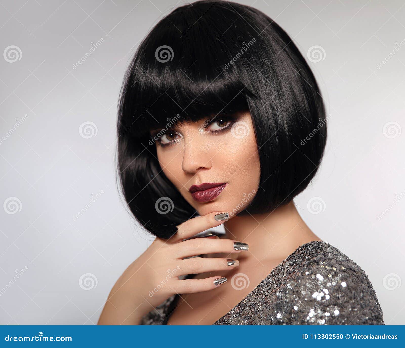 black bob hairstyle. beauty makeup, silver manicured polish nail