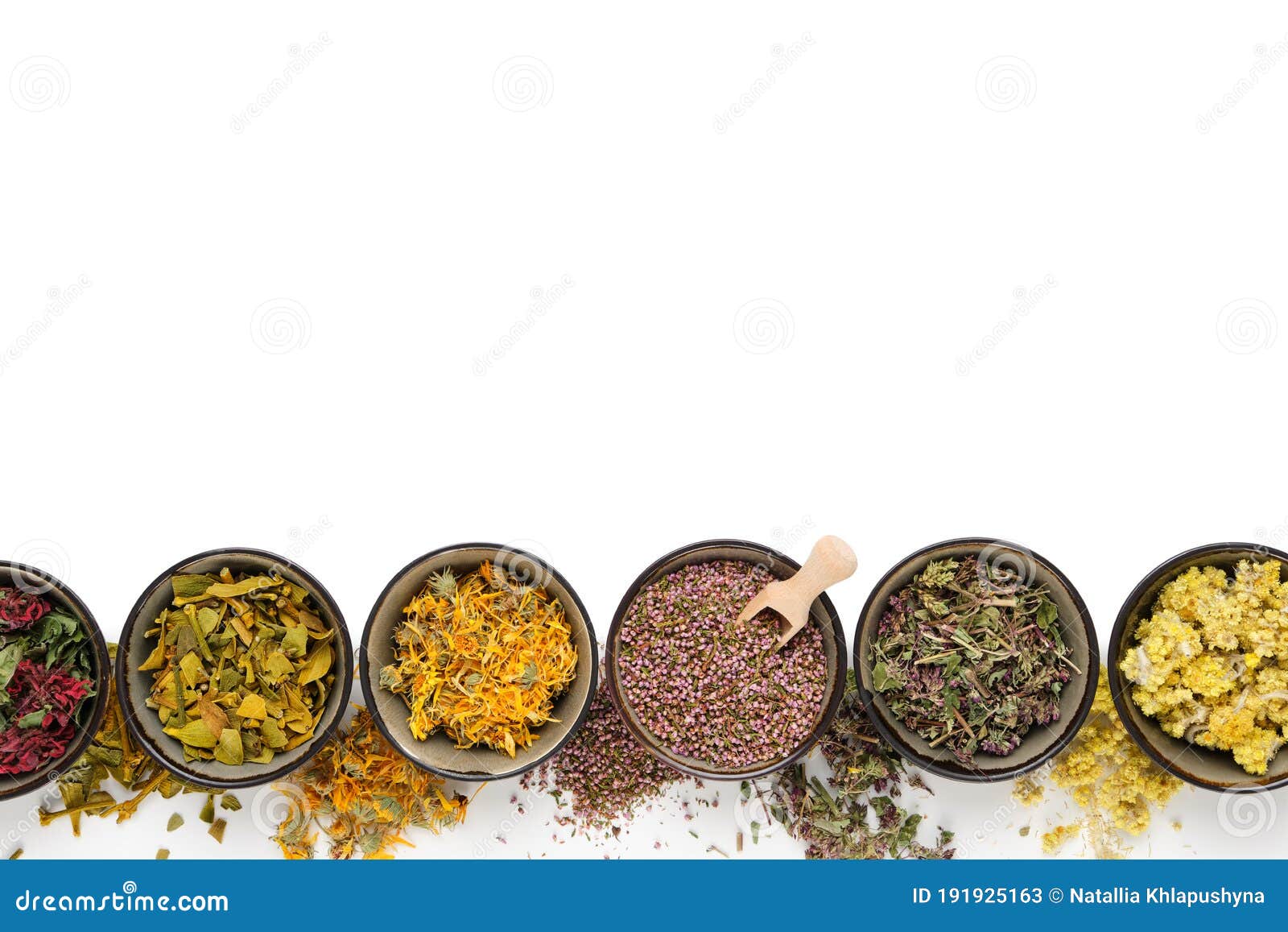 black bowls of dry medicinal herbs on white background. top view, flat lay. alternative medicine.