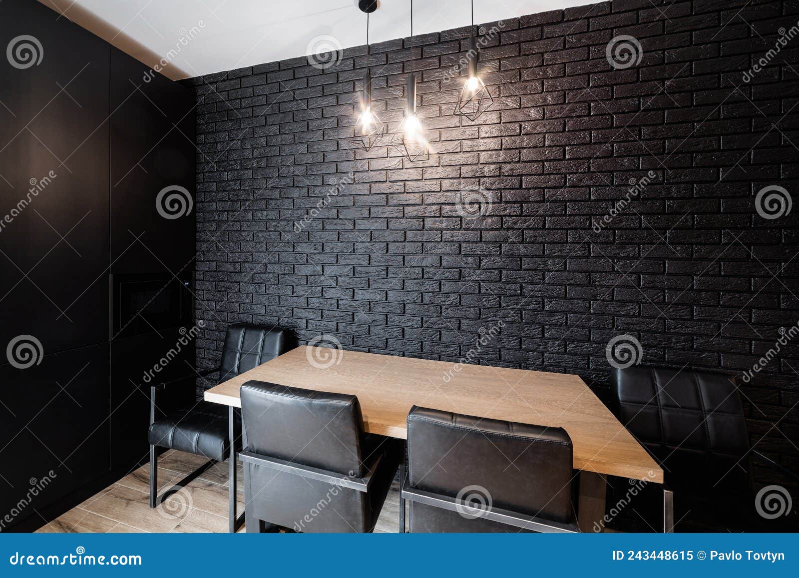 Black Brick Wall and Table with Chairs in the Kitchen Stock Image
