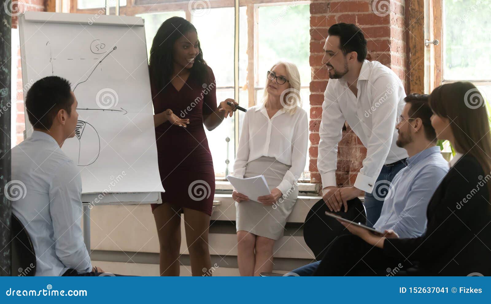 black business woman coach training team giving flip chart presentation