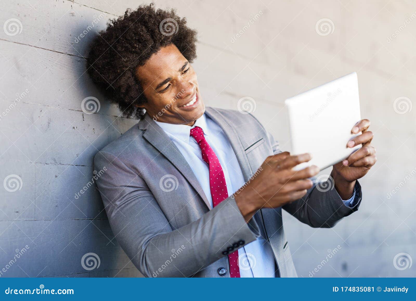 black businessman using a digital tablet in urban background