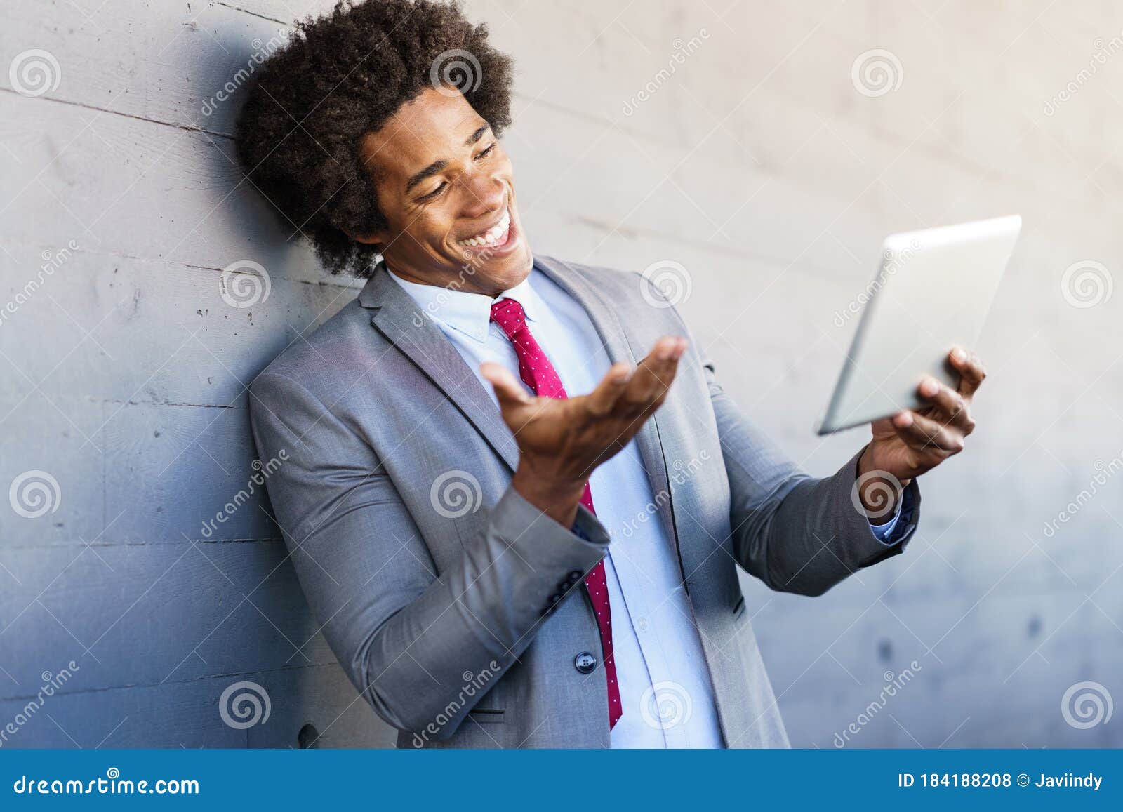 black businessman using a digital tablet in urban background