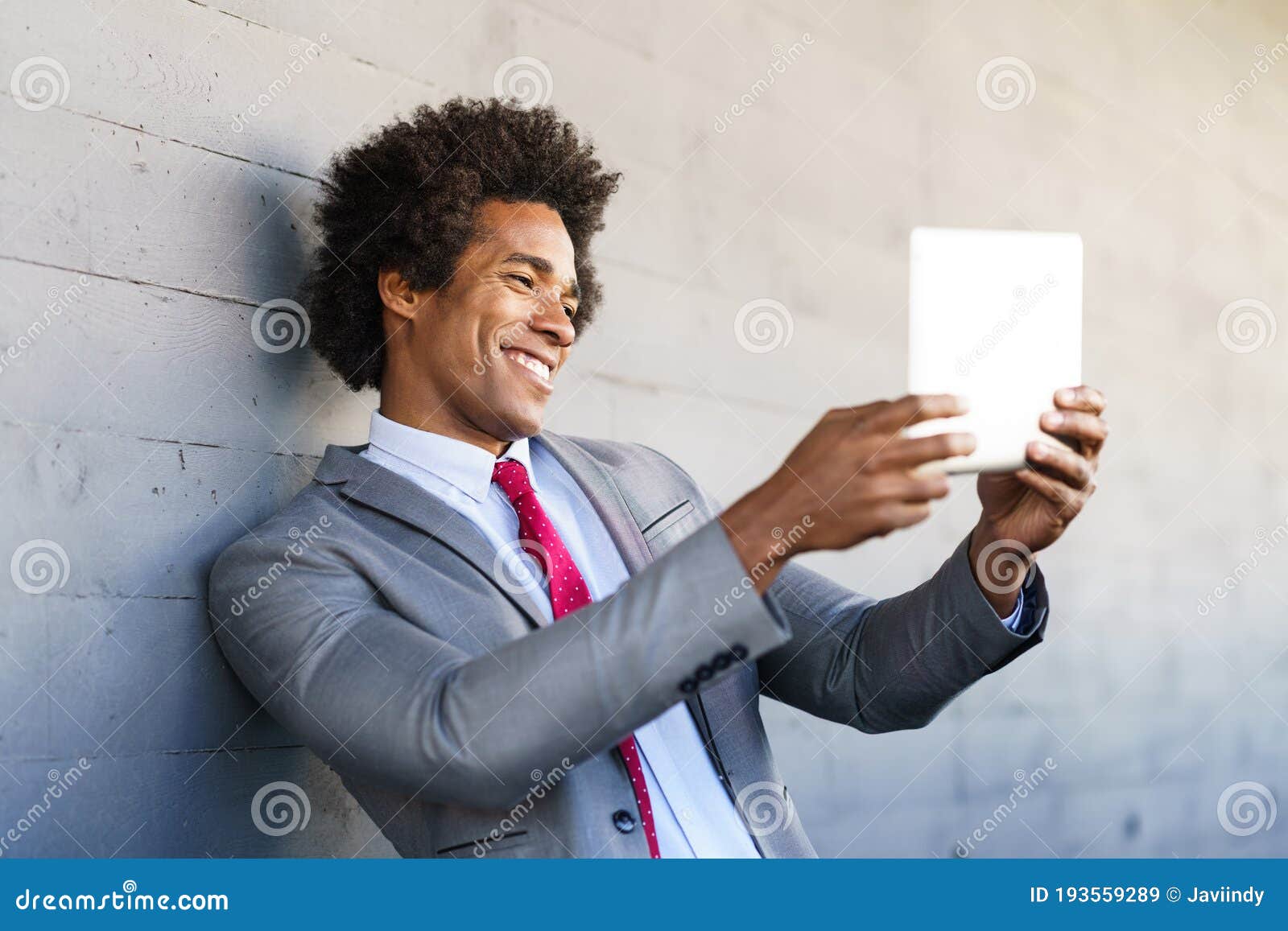 black businessman using a digital tablet in urban background