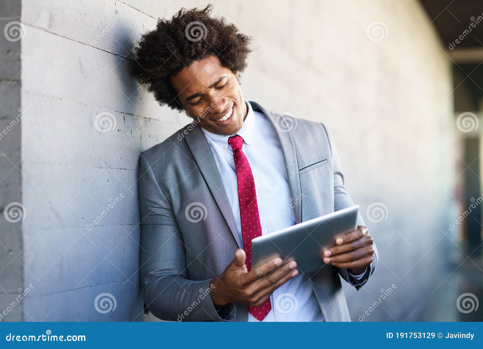 black businessman using a digital tablet in urban background