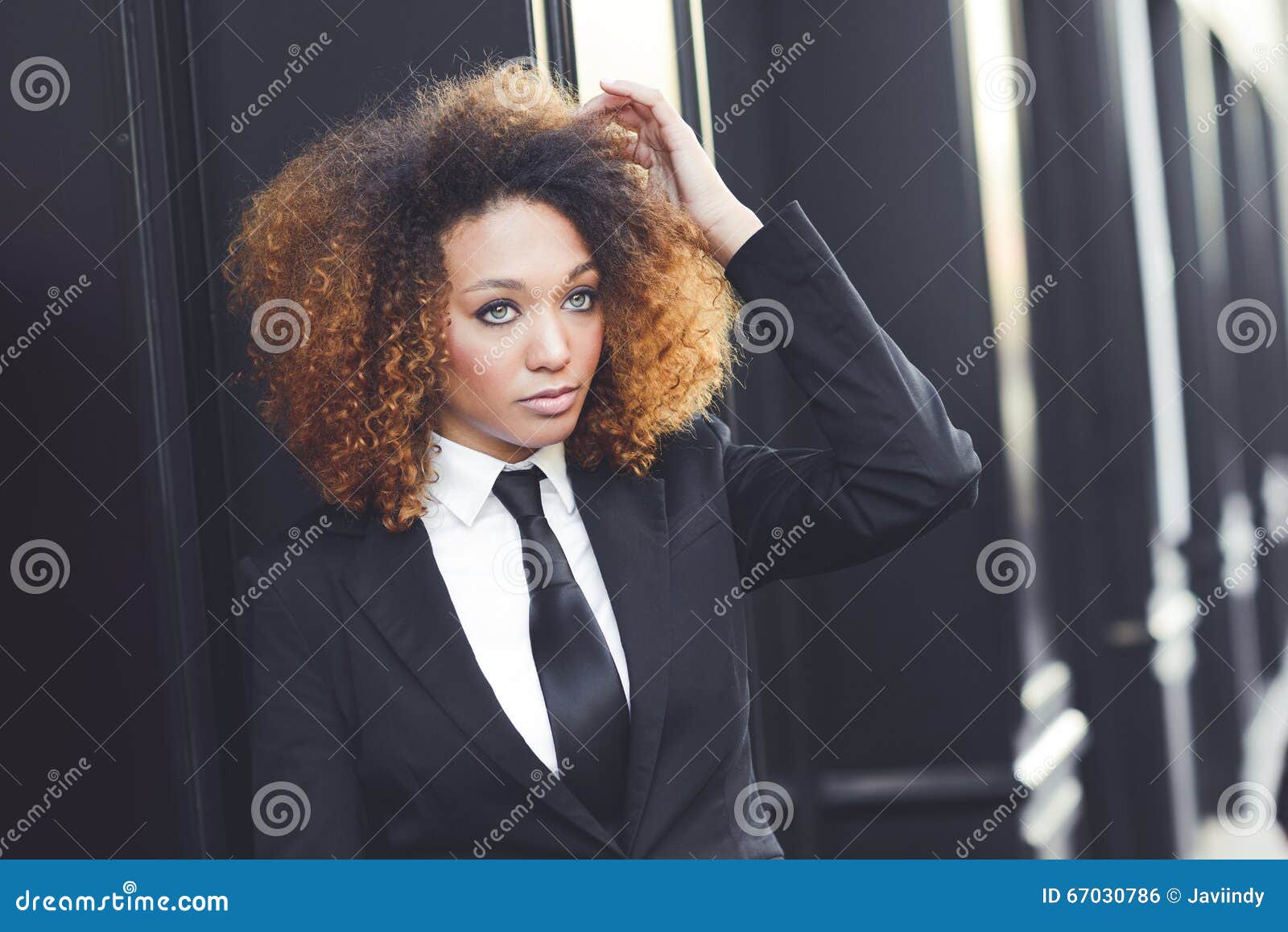 Black Businesswoman Wearing Suit And Tie In Urban Background Stock ...