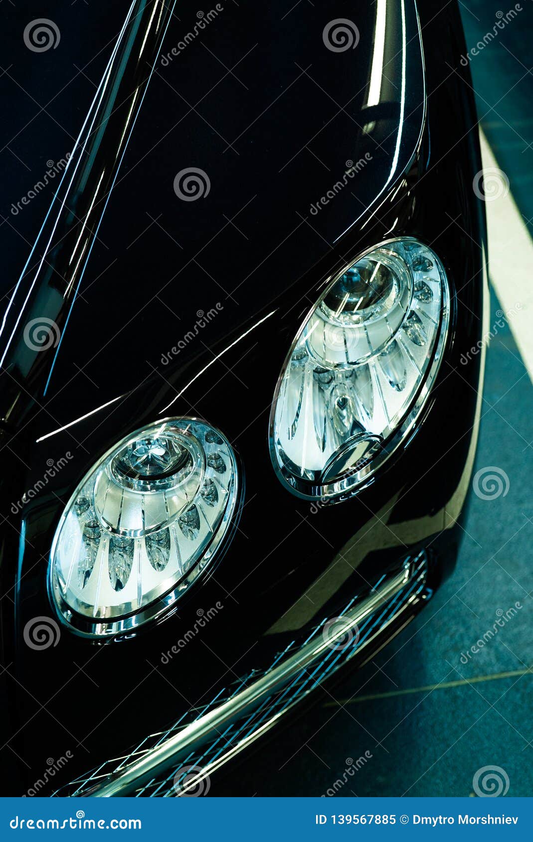 Headlight of a Modern Luxury Black Car Concept in the Garage Stock