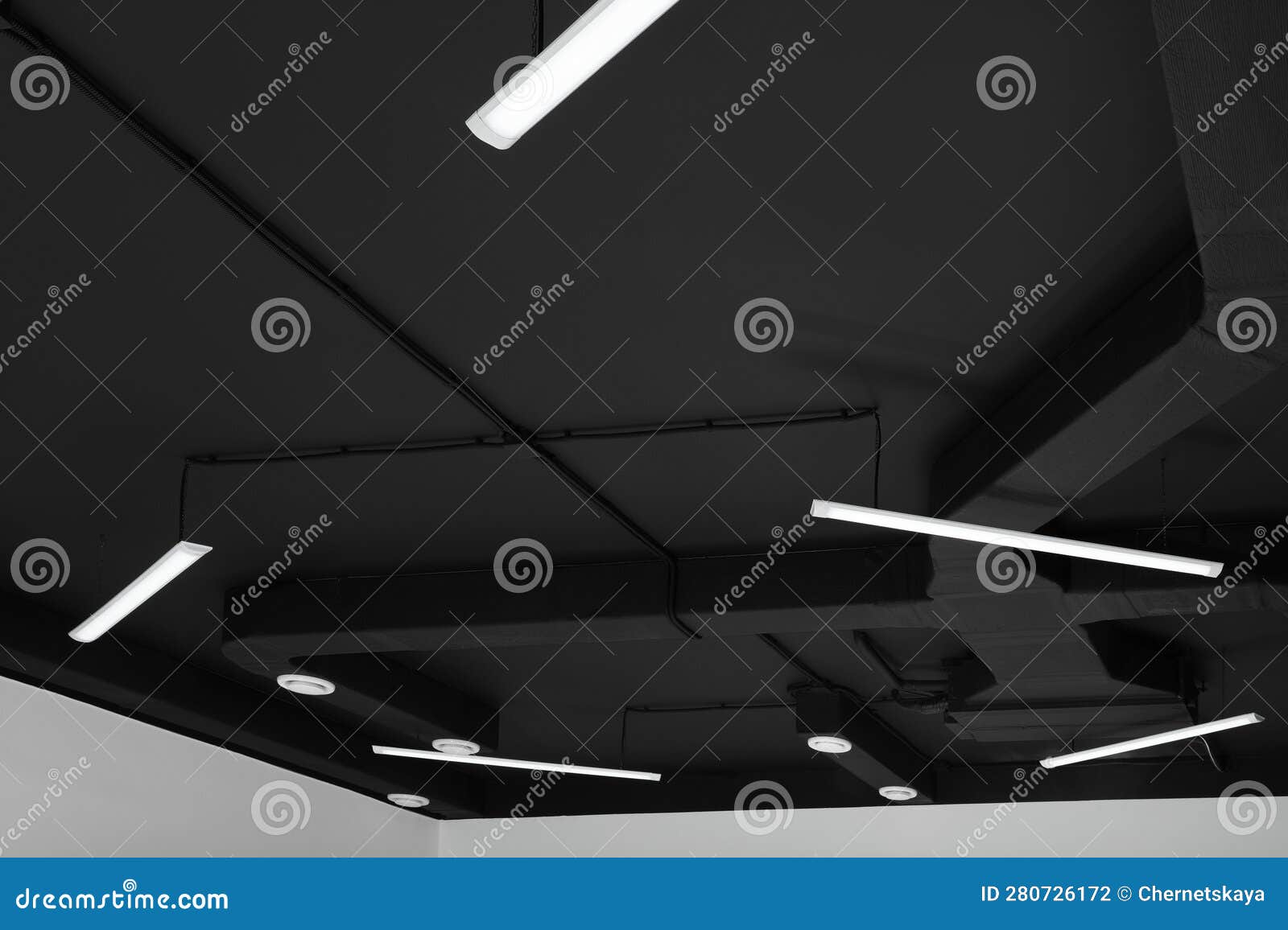 Black Ceiling with Modern Lighting in Room, Low Angle View Stock Photo