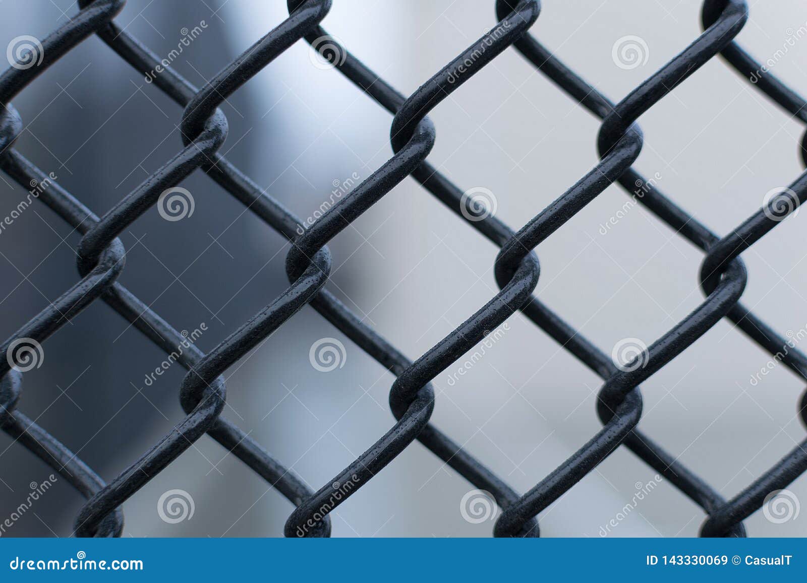 Black Chain Link Fence Against A Smooth Blurred Out Background, Closeup ...
