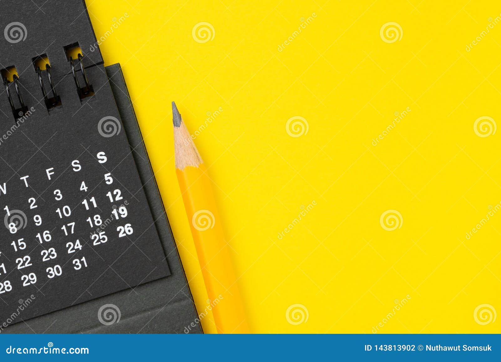 Black Clean Calendar With Yellow Pencil On Solid Yellow Background