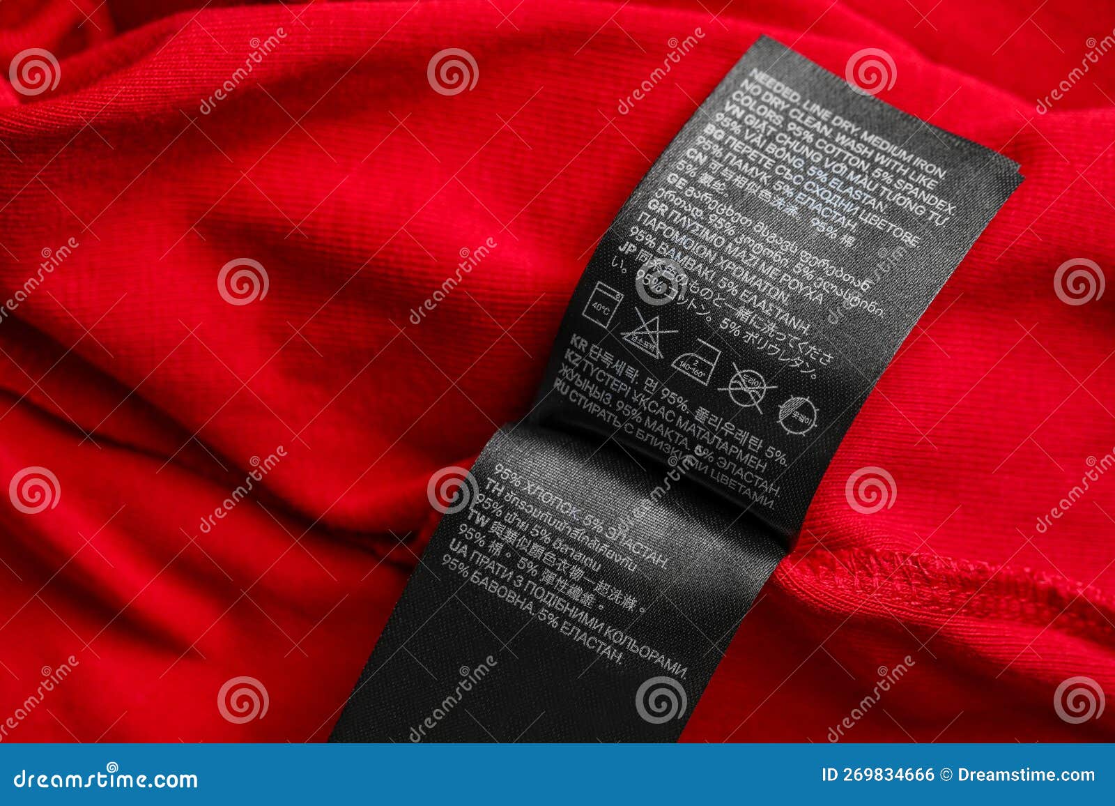 Black Clothing Labels on Red Garment, Top View Stock Photo - Image of ...