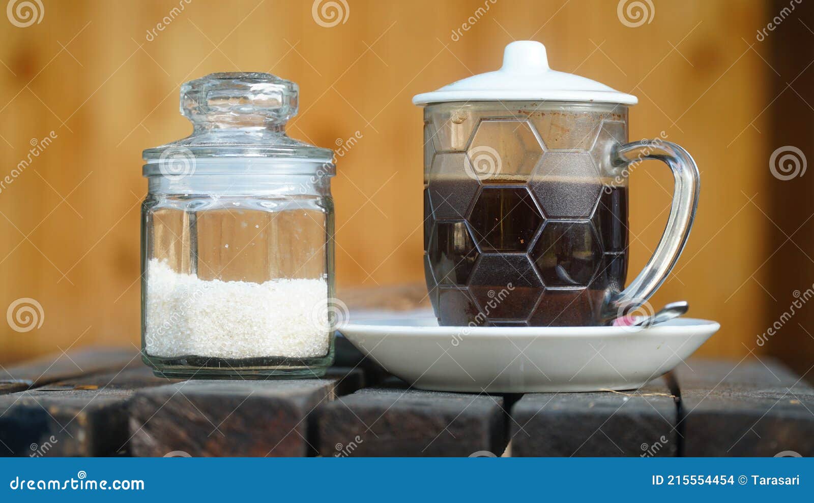 Black Coffee and Sugar in a Glass Cup. Focus Selected Stock Photo