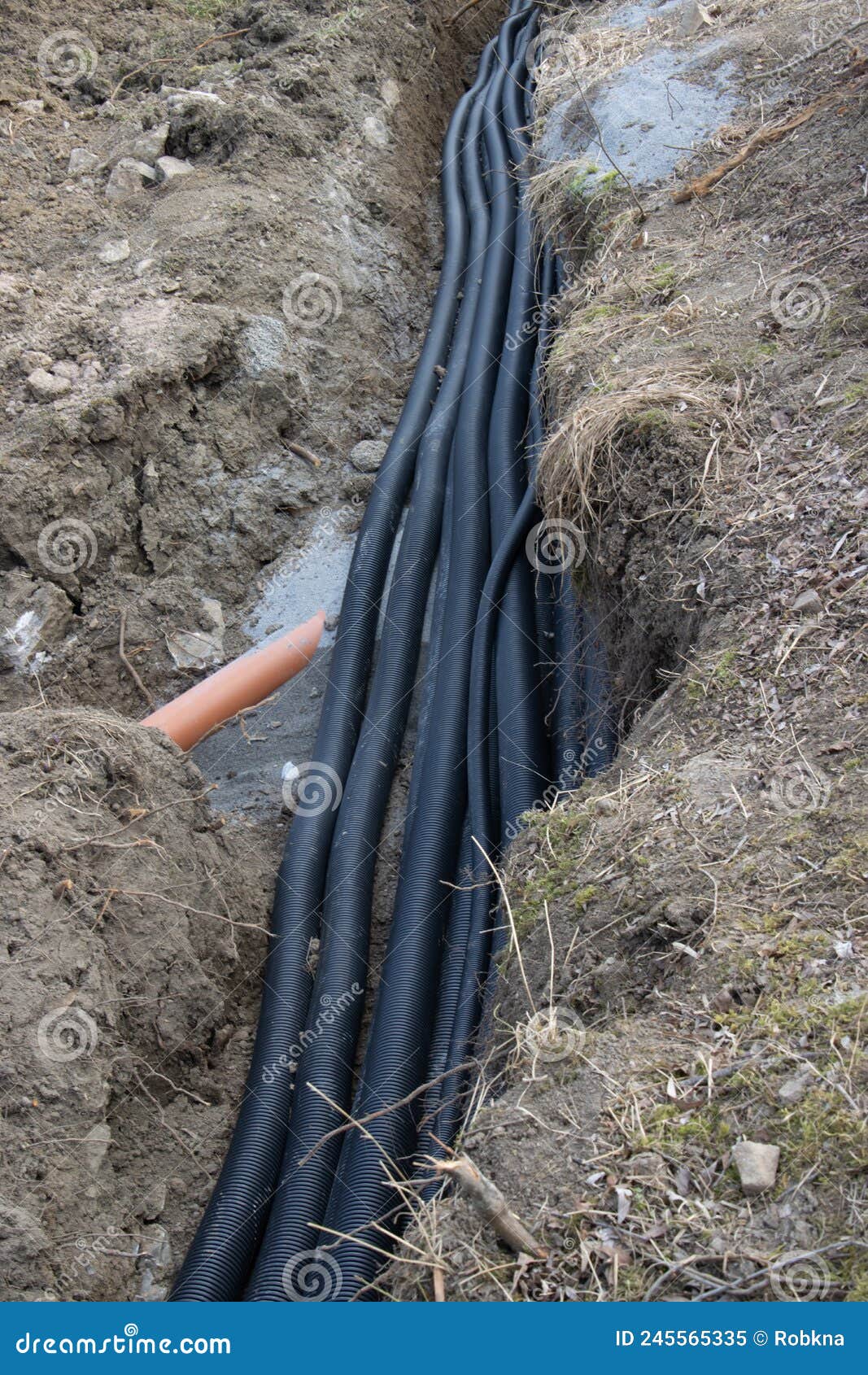 Black Corrugated Plastic Drainage Pipes Laying in a Ditch at a