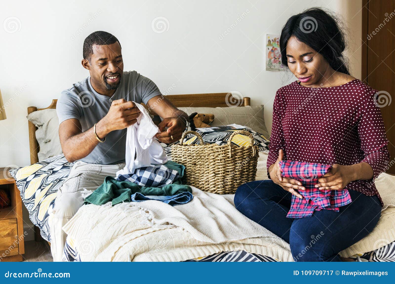 black couple folding clothes together