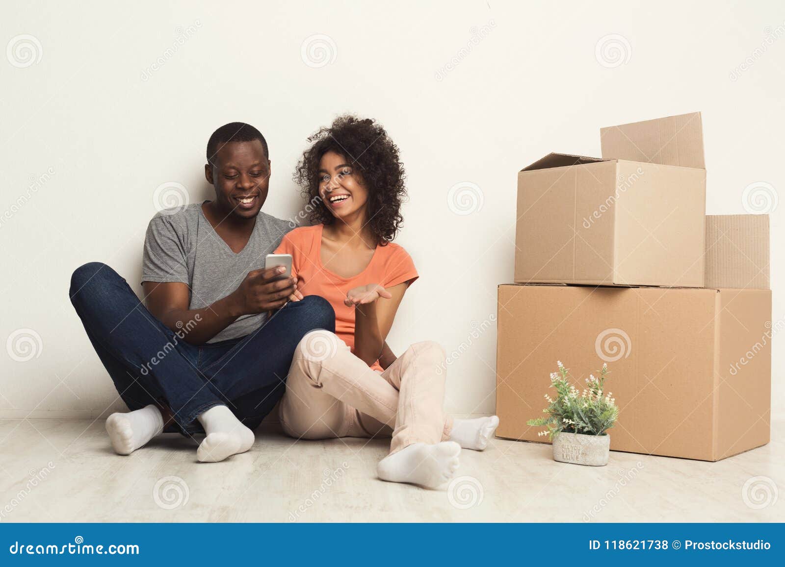 Black Couple Sitting On Floor At New Apartment Stock Photo
