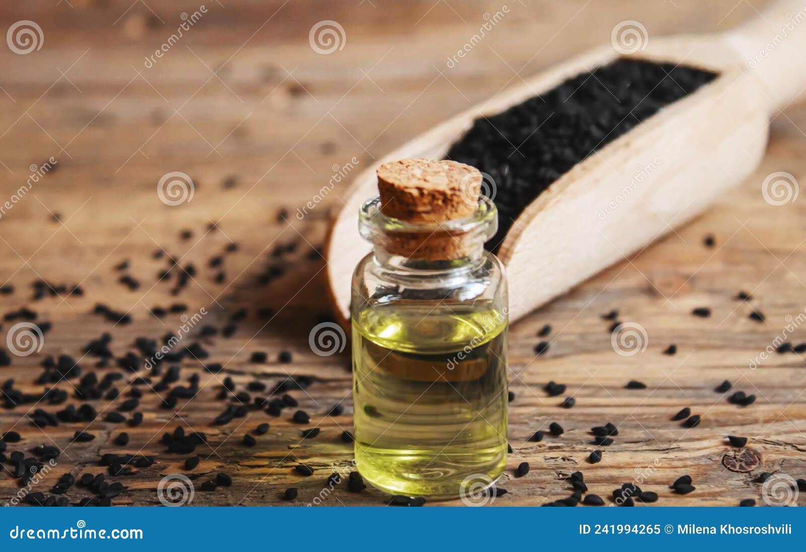 Black Cumin Essential Oil in a Small Bottle. Selective Focus Stock