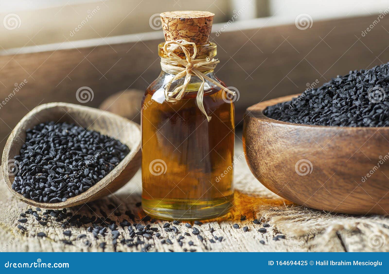 Black Cumin Seeds Essential Oil , Nigella Sativa In Spoon On Wooden ...