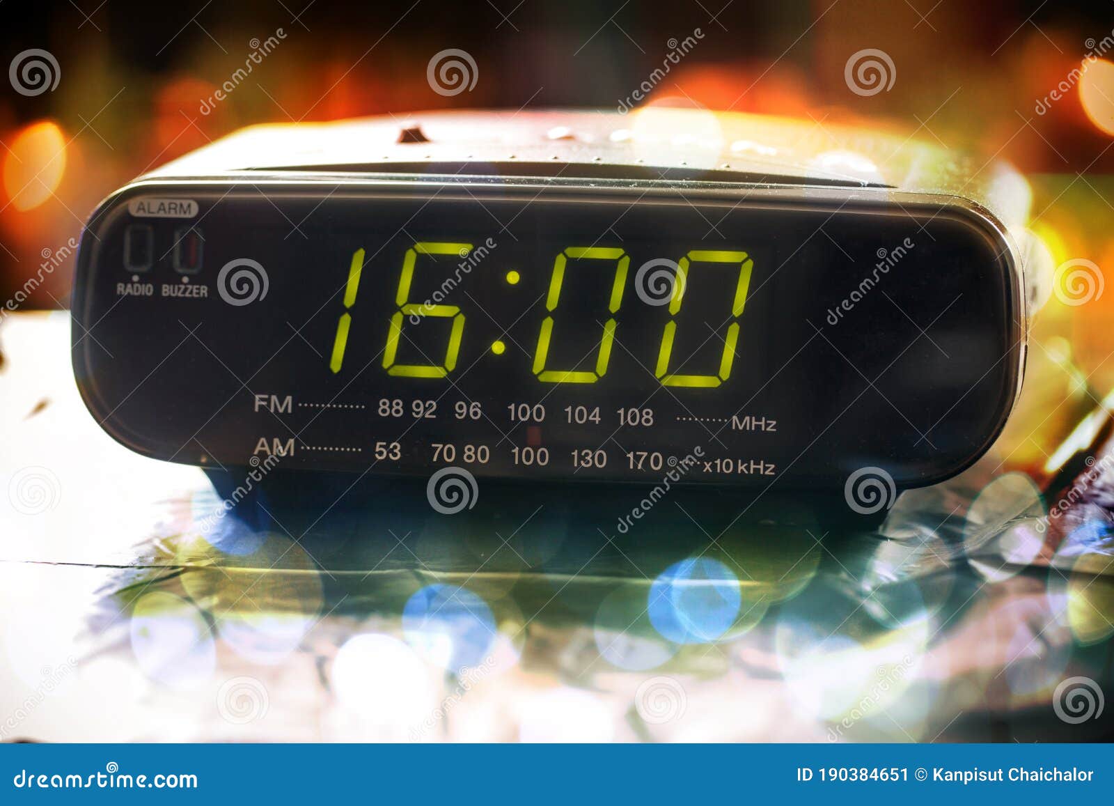 black digital alarm radio clock.alarm radio clock indicating time to wake up.digital clock closeup displaying 16:00