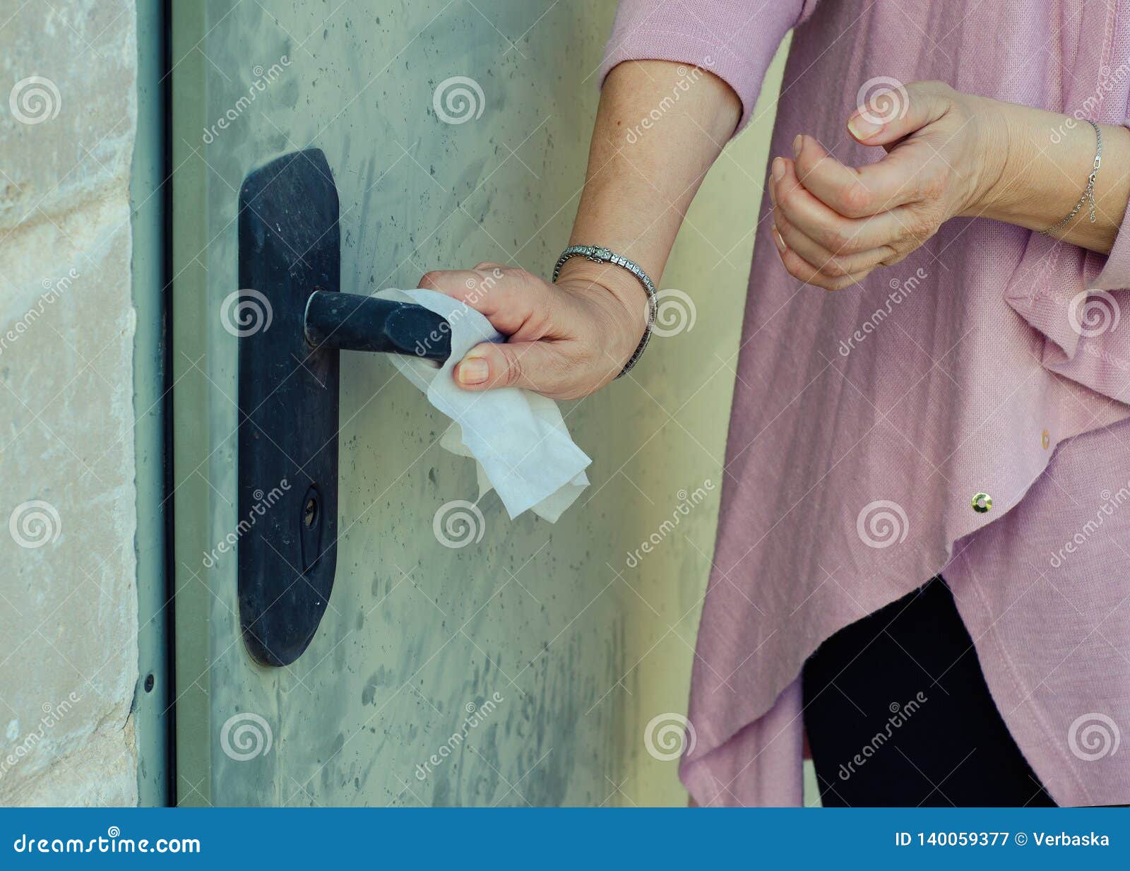 a woman suffering germophobia presses dirty door handle