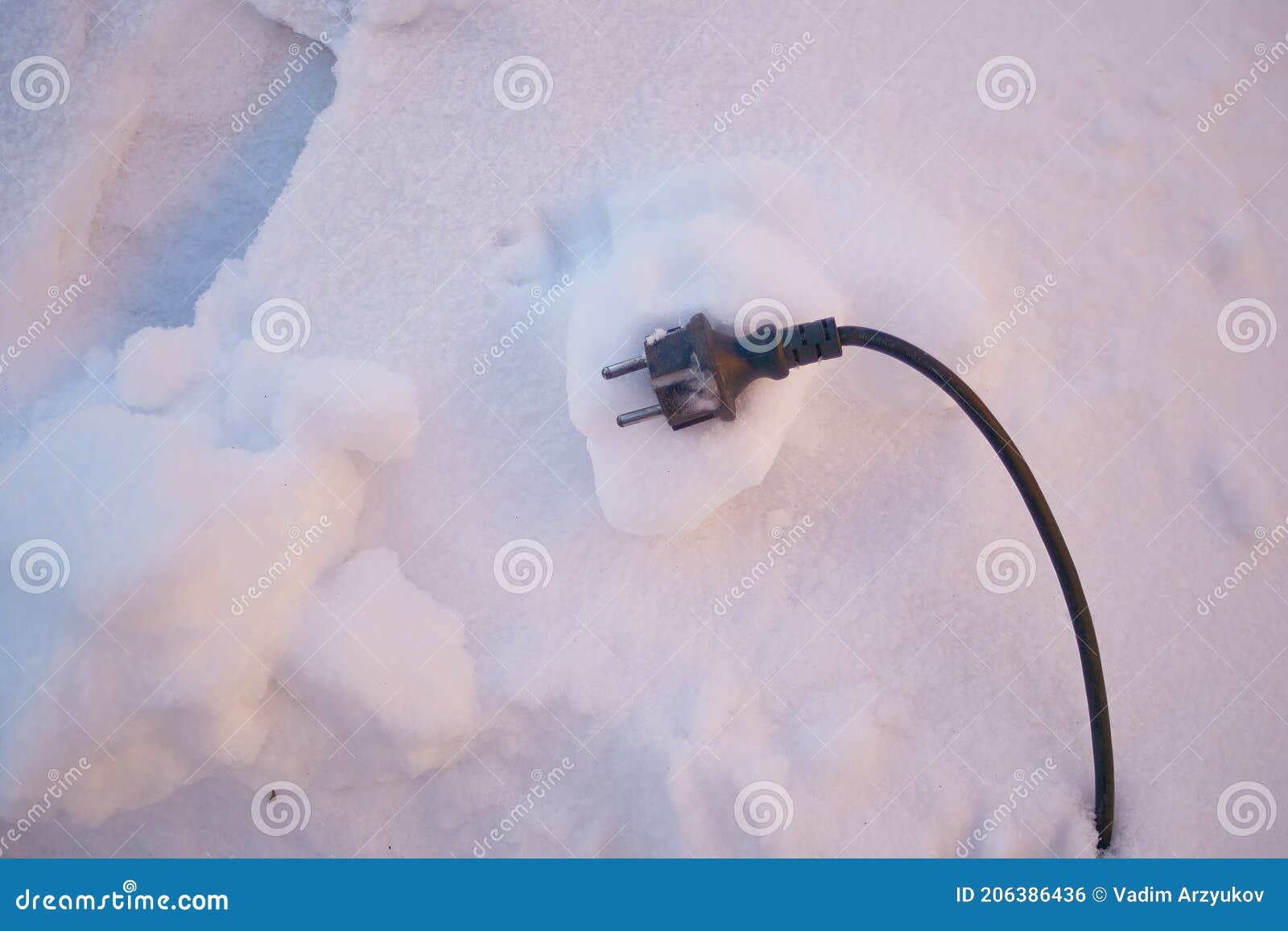 black electric wire from the device lies on the snow
